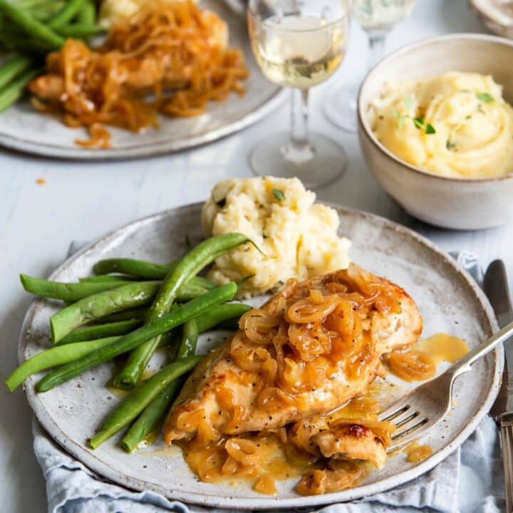 Baked Chicken and Shallots on grey plate with wine