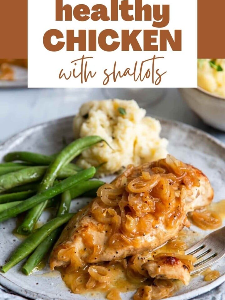 Chicken with shallots served on a plate with green beans.