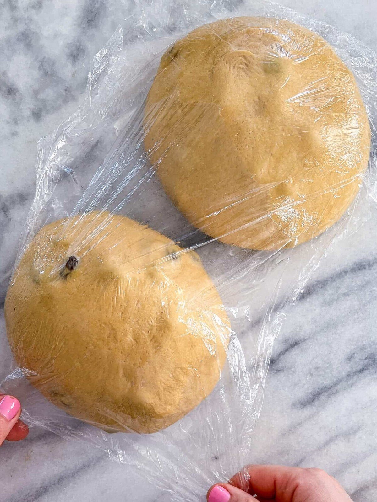Old Fashioned Raisin Bread Dough shaped on marble.