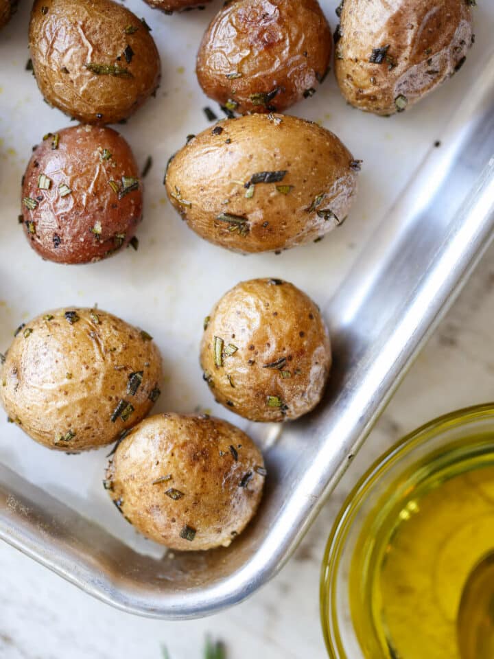 Rosemary Roasted Potatoes on baking sheet with olive oil