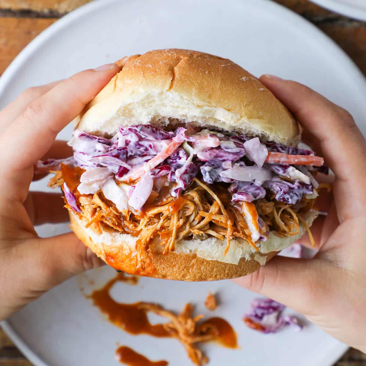 Slow cooker barbecue pulled chicken sandwich hand held