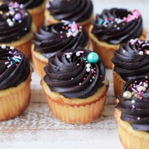 Yellow Cupcakes with Chocolate frosting multi colored sprinkles