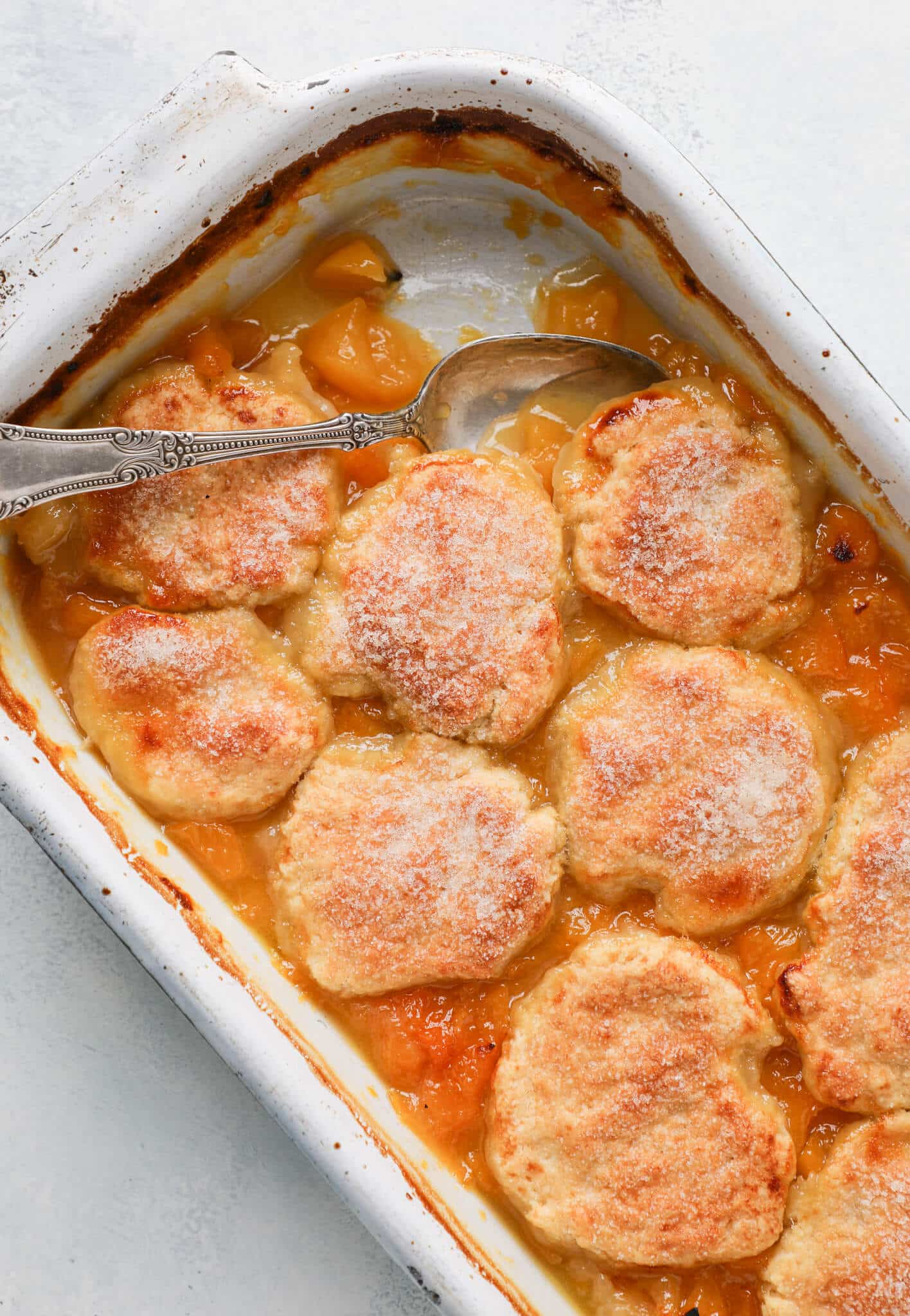 Old Fashioned Peach Cobbler baked in vintage dish