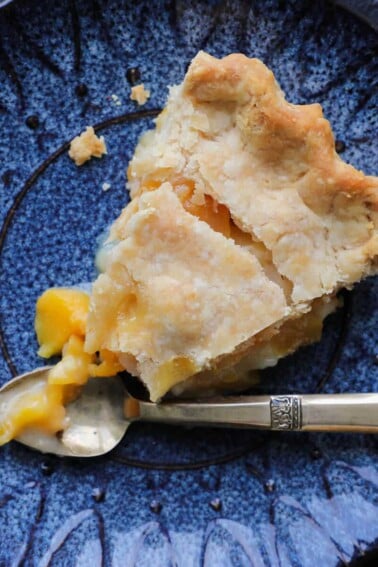 Old Fashioned Peach Pie sliced with vintage gold fork