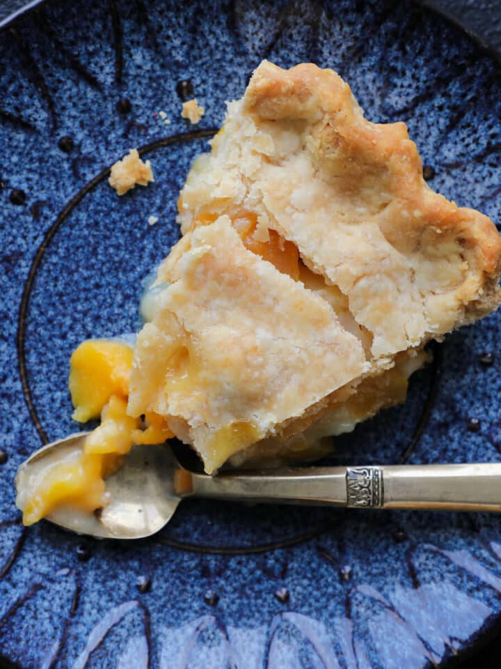 Old Fashioned Peach Pie sliced with vintage gold fork