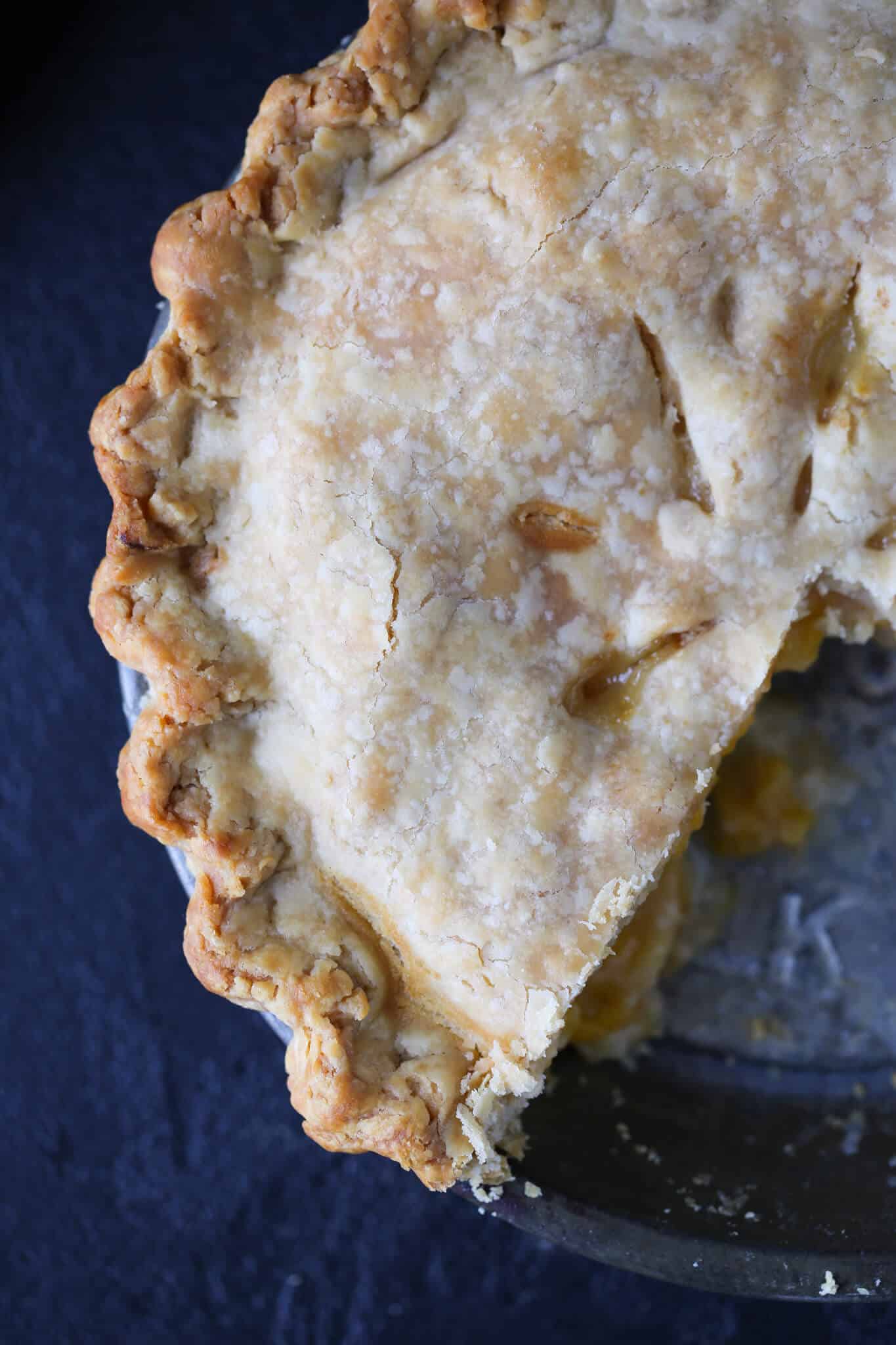 Old Fashioned Peach Pie sliced in vintage pie tin.