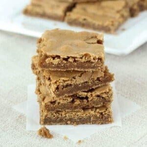 Stacked brown butterscotch brownies cut in squares.