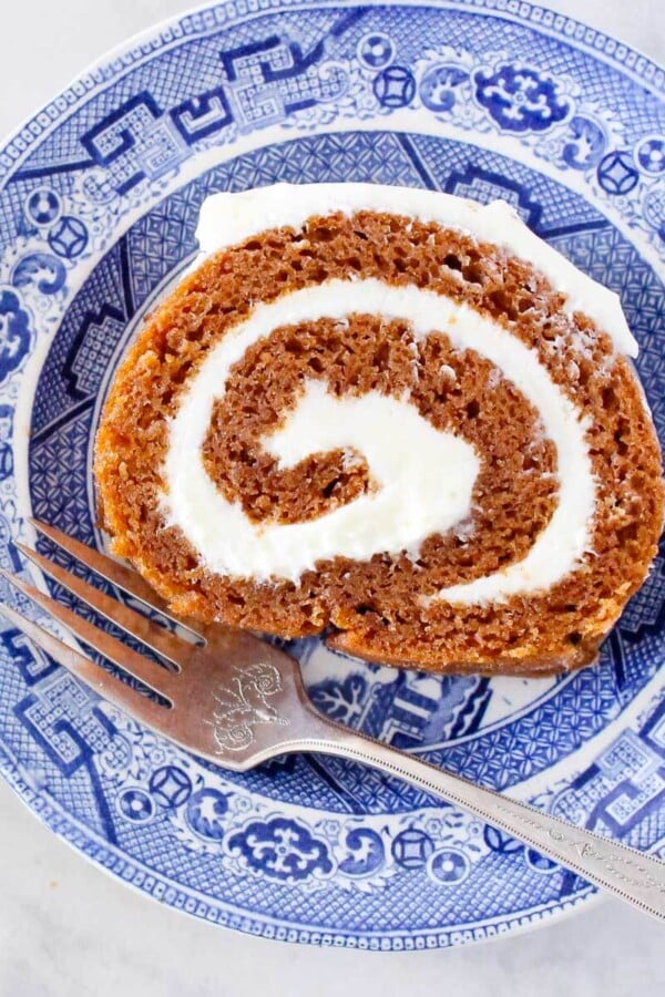slice of pumpkin roll on plate with fork.