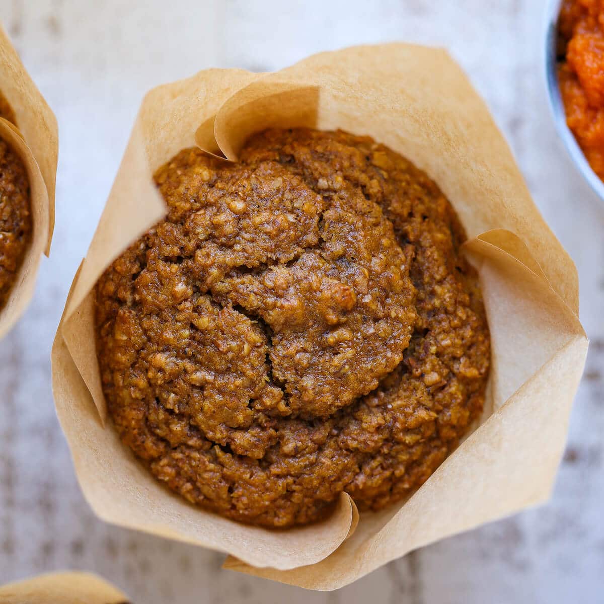 baked muffin in brown tulip liner. 