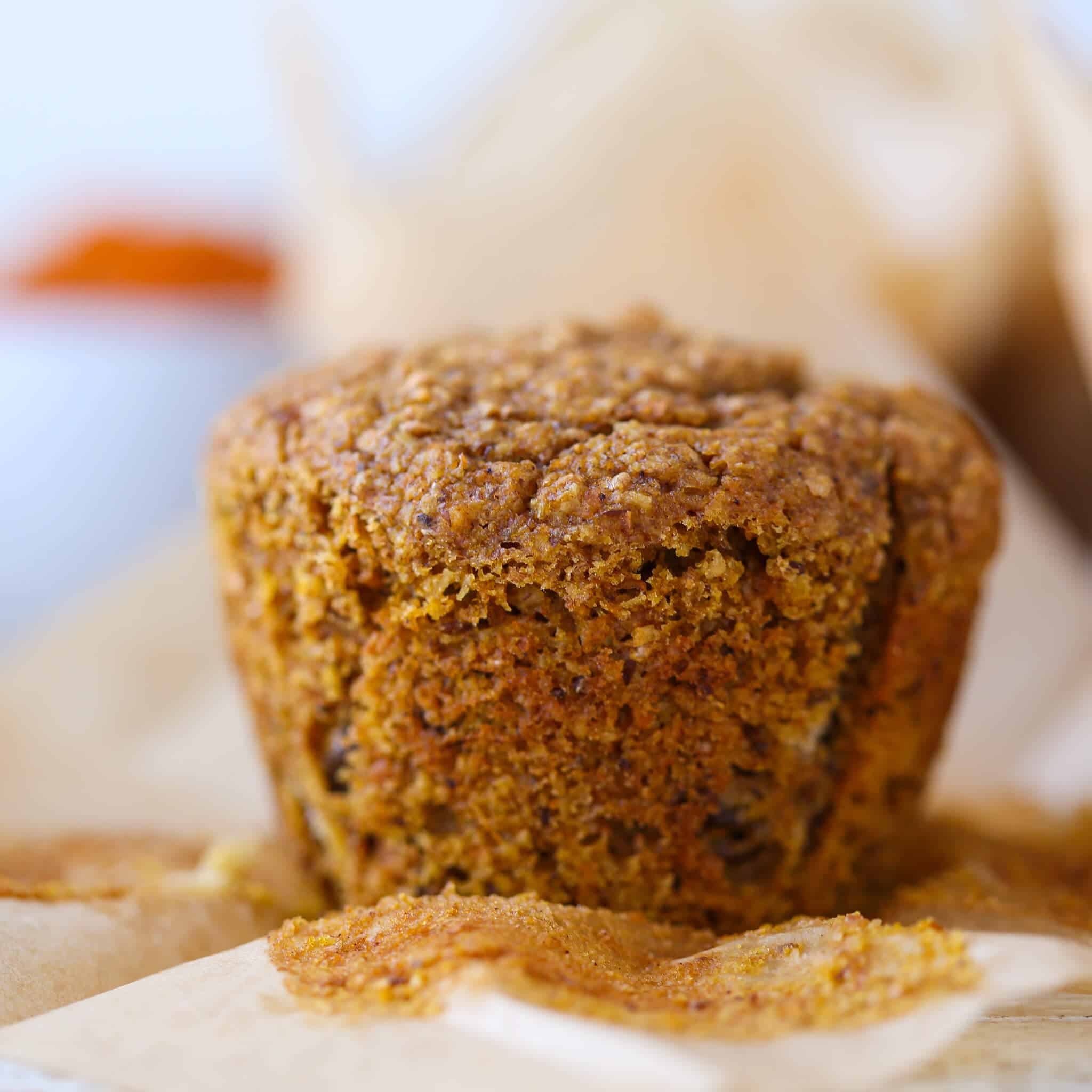 pumpkin muffin unwrapped to show baked texture. 