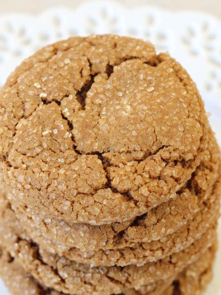 Molasses Spice Cookies stacked on white lace plate