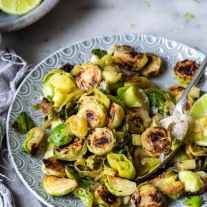 Brussels Sprouts and Leeks with Lime ginger butter plated on grey plate