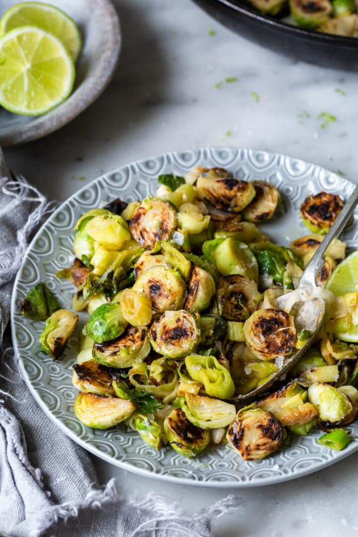 Brussels Sprouts and Leeks with Lime ginger butter plated on grey plate