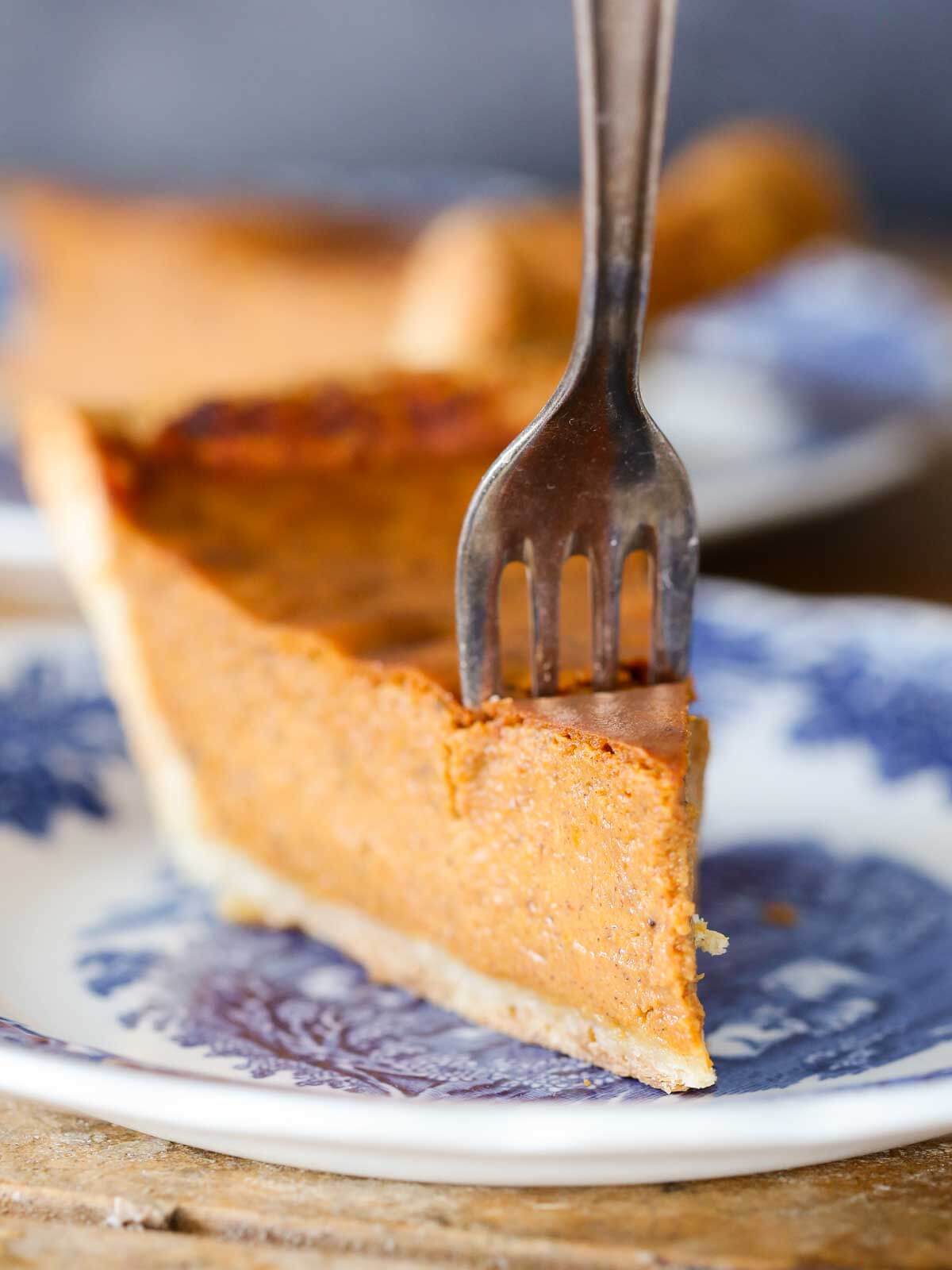 pumpkin pie slice with fork in it.