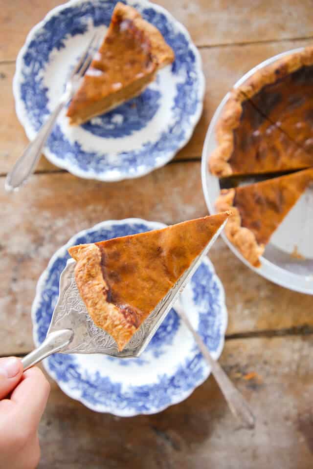 Foolproof Pumpkin Pie slice on pie server over blue plates