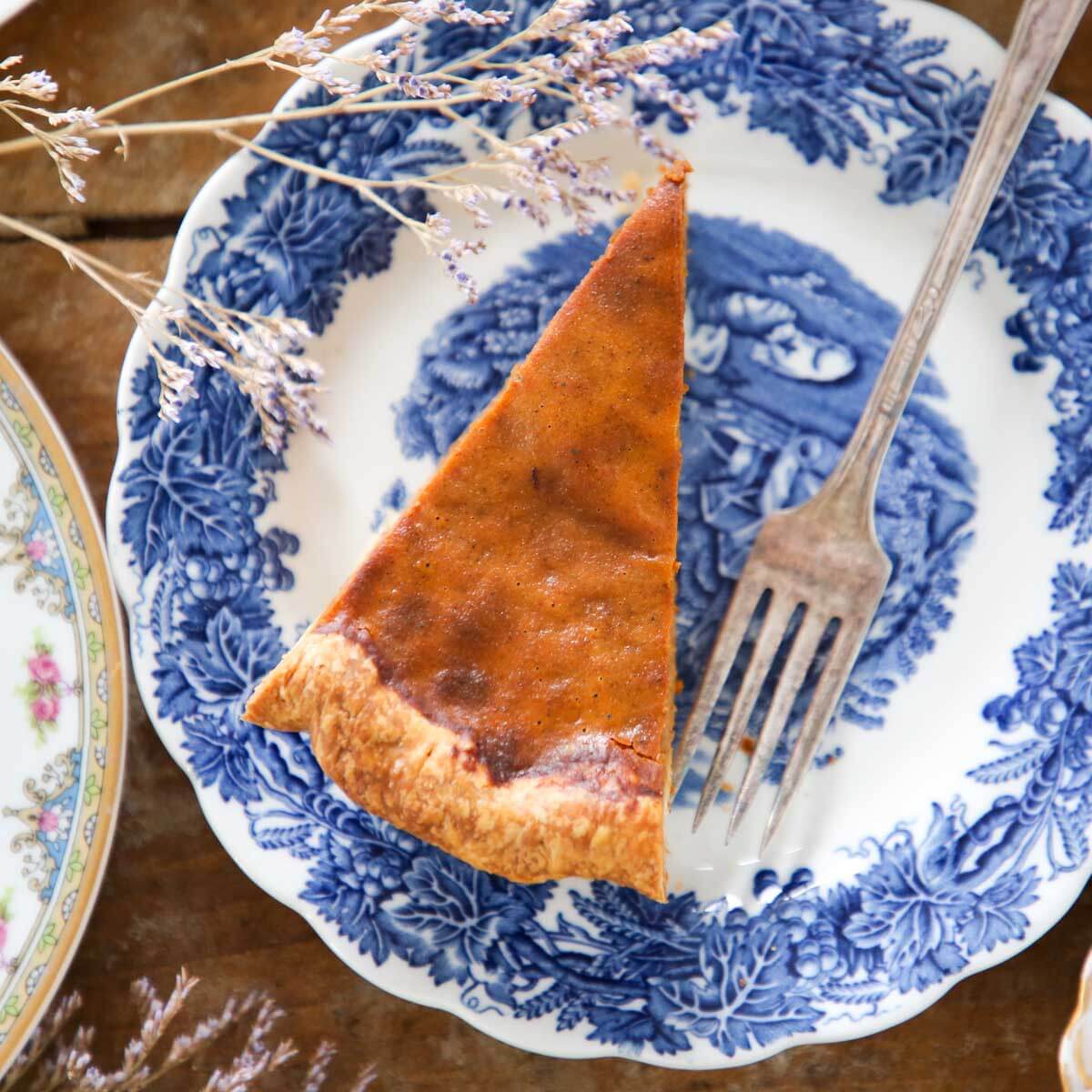 pumpkin pie slice on vintage blue plate with flowers: