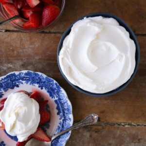 Lemon Whipped Cream in blue bowl with strawberries