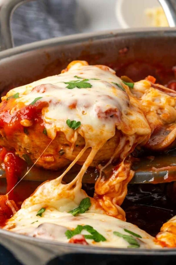 cheesy chicken being served from pot.
