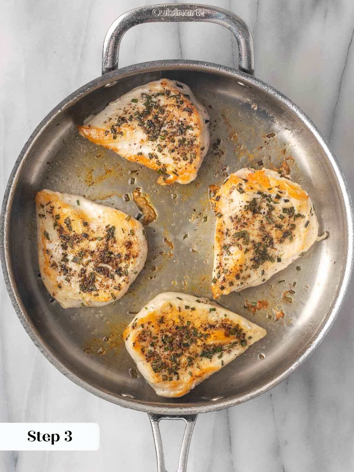 seared chicken breasts in pan.