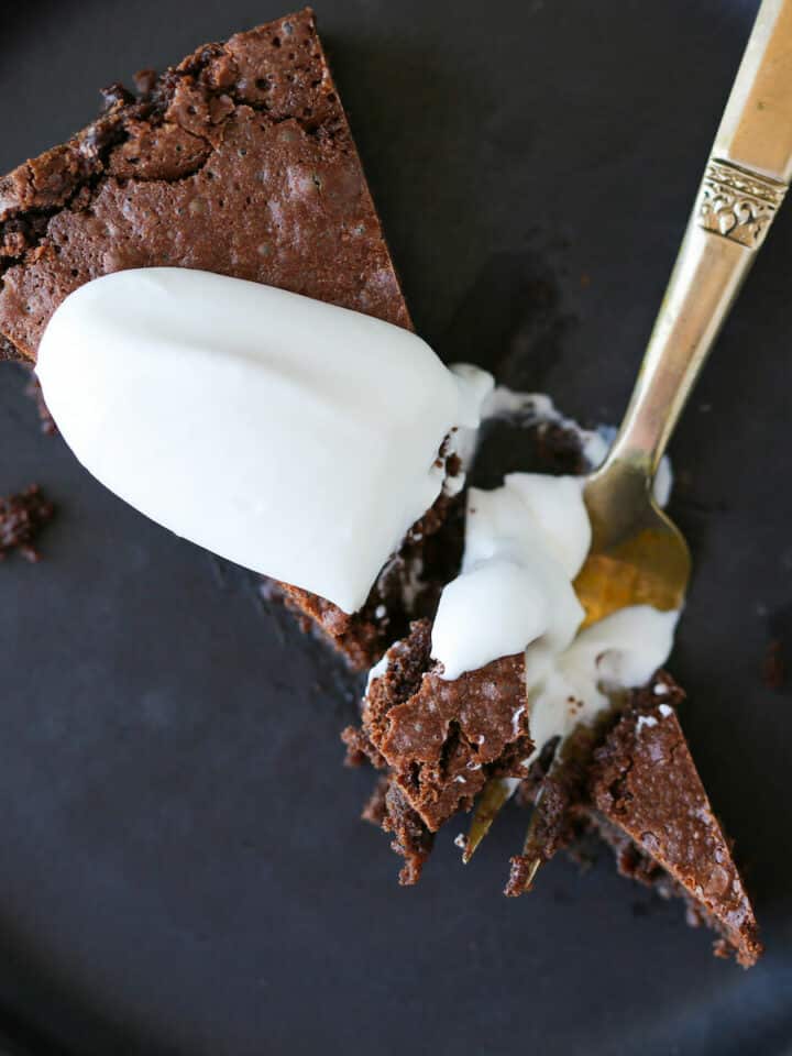 Flourless Chocolate Decadence Cake slice with creme fraiche whipped cream Romantic Sweets Recipes