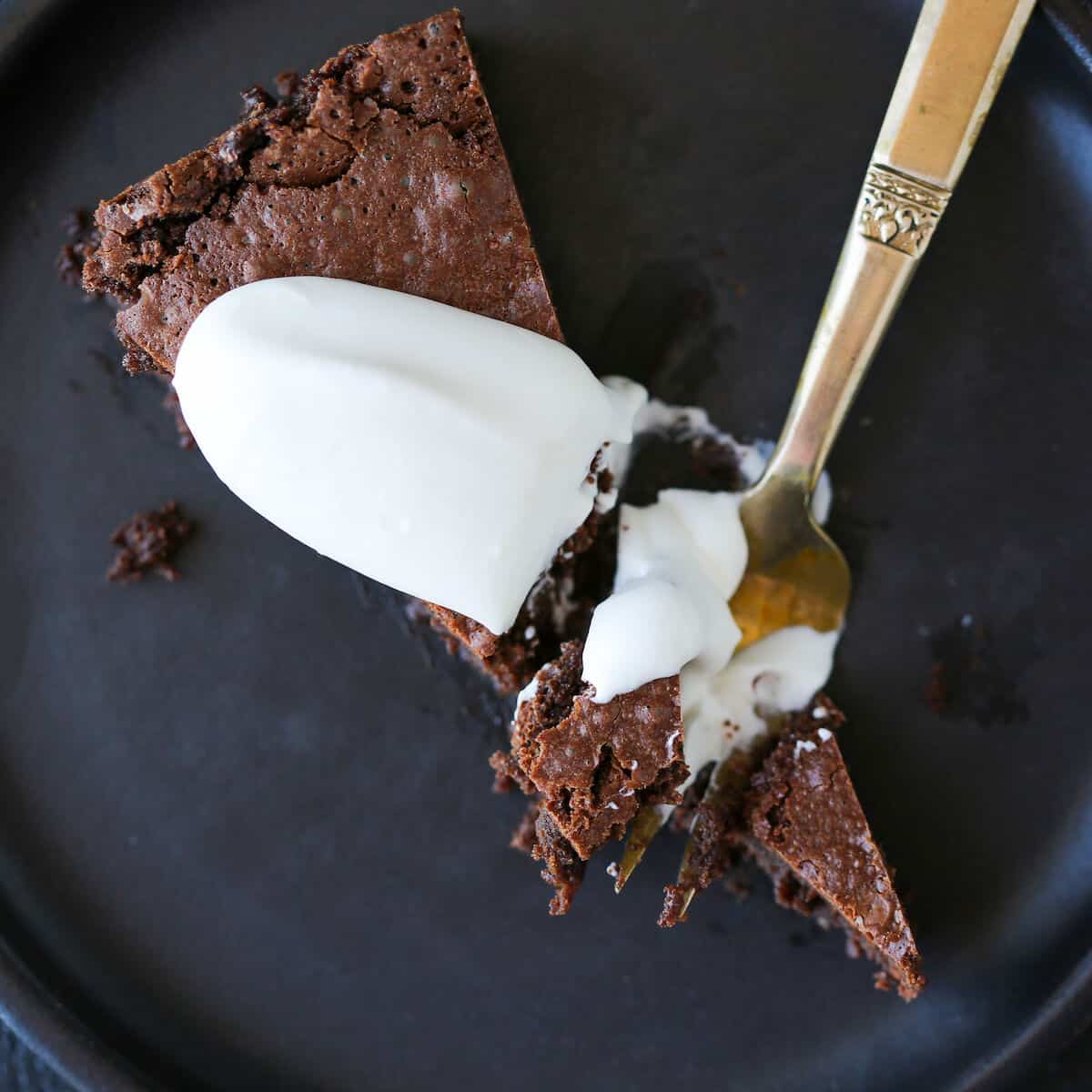Flourless Chocolate Decadence Cake slice with creme fraiche whipped cream Romantic Sweets Recipes.