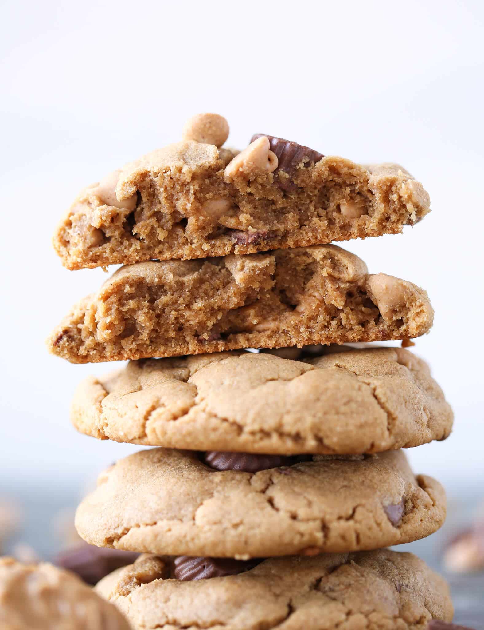 Loaded Reeses Peanut Butter Cookies stacked broken open easy chocolate dessert recipes.