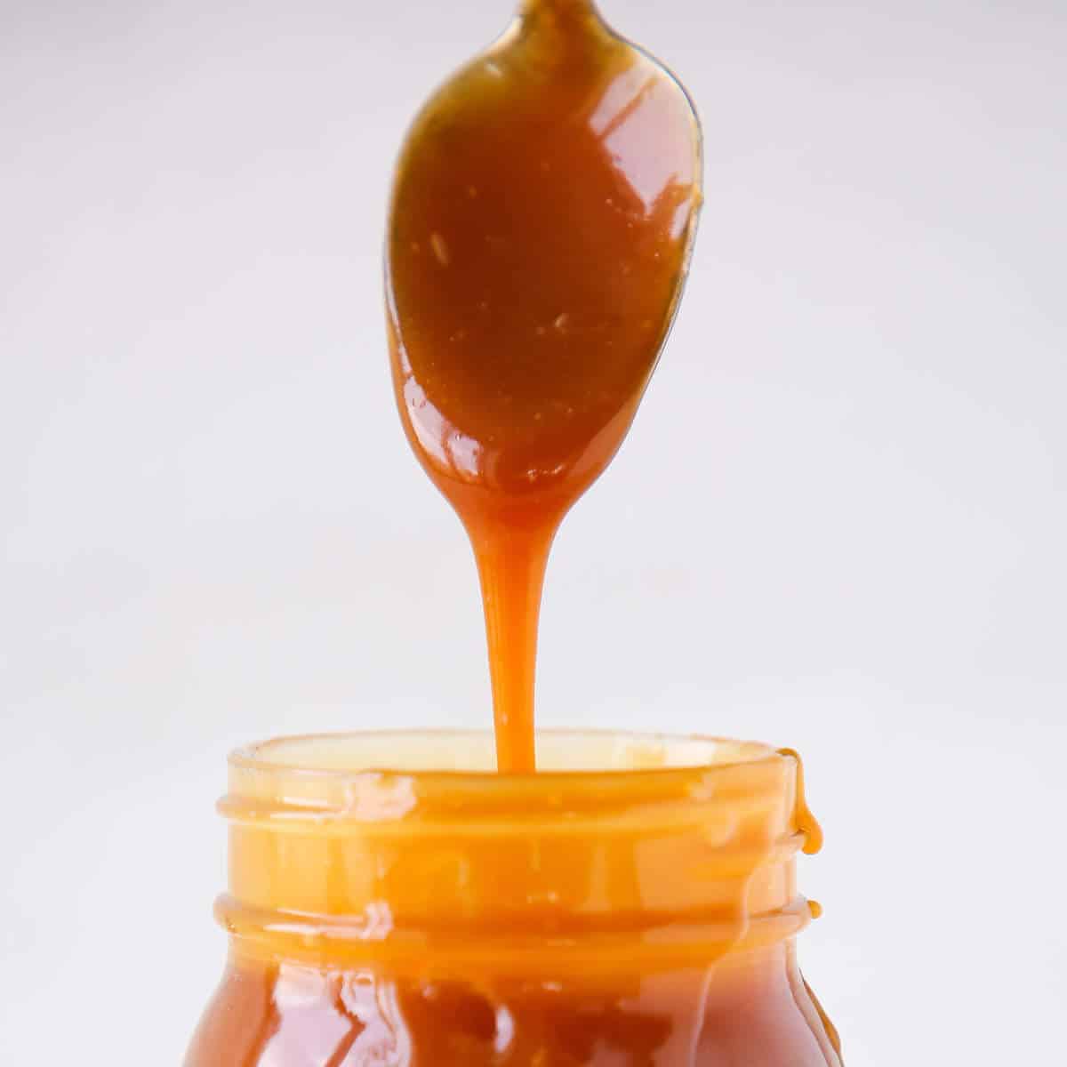 salted caramel sauce dripping from spoon. 