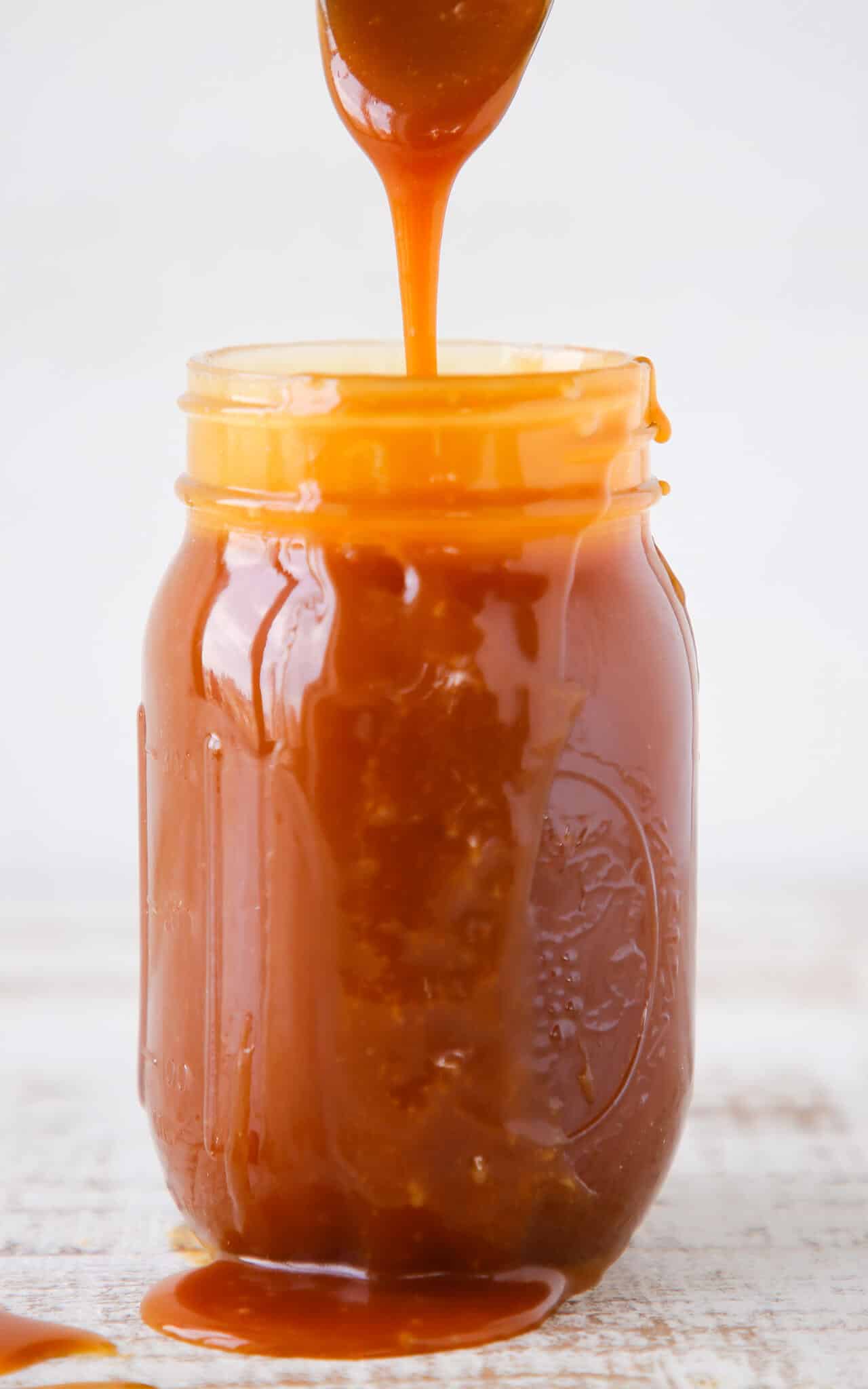 The Best Salted Caramel Sauce spoon pouring