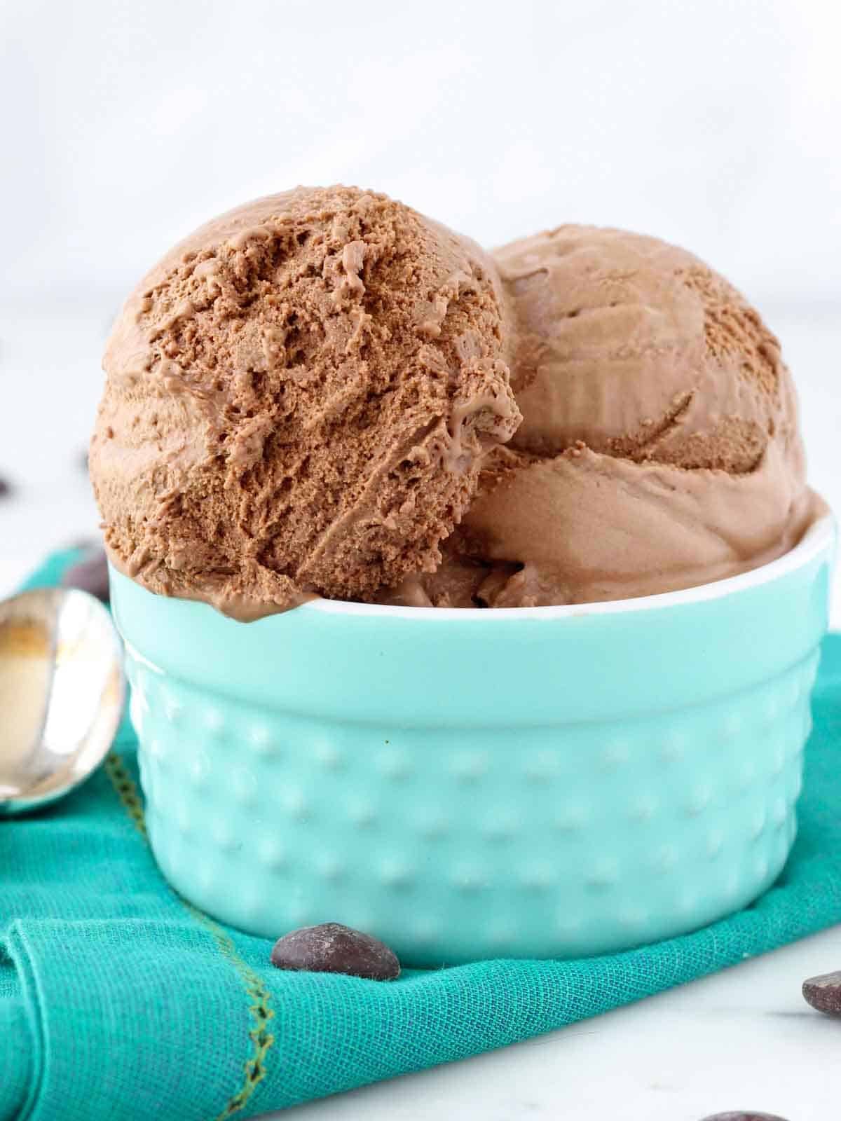 3 scoops of chocolate ice cream in teal bowl.