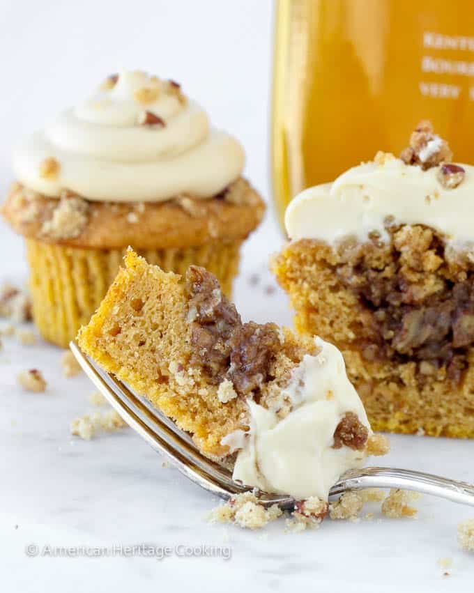 cupcake sliced open on fork white background.