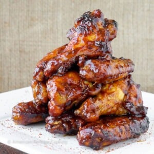 A pile of baked chicken wings in a perfectly thick sauce.
