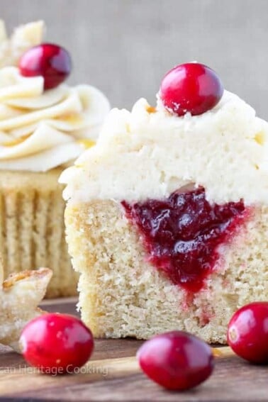 Spiced Apple Cider Cranberry Cupcakes | Soft, moist apple cider cinnamon cake filled with spiced cranberry compote and topped with a cinnamon cream cheese butter cream! And don't forget the sugared pie crust leaf!