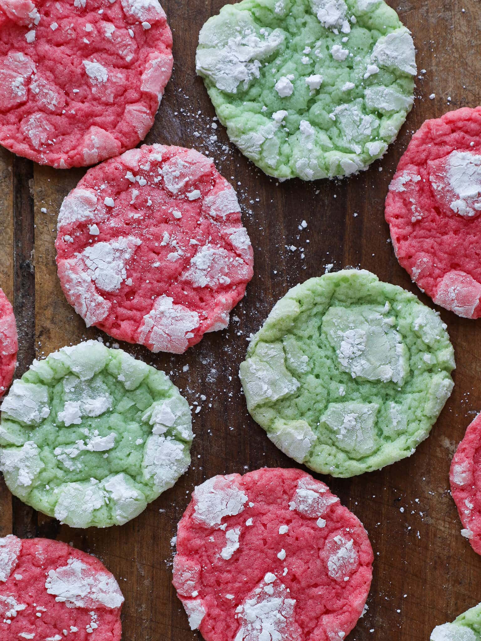 Festive Almond Crinkle Cookies arranged on wooden surface easy Christmas cookies.