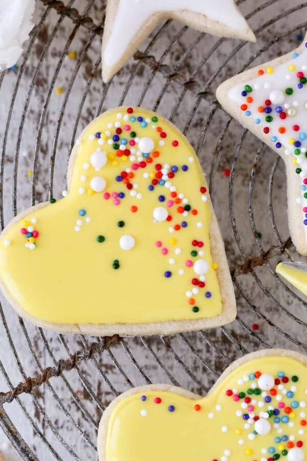icing yellow heart shaped sugar cookies.