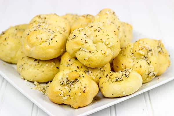 These Parmesan Garlic Knots are an easy, addicting appetizer! Soft homemade pizza dough is brushed with butter and sprinkled with garlic and Parmesan cheese! A perfect recipe for Game Day or any party!