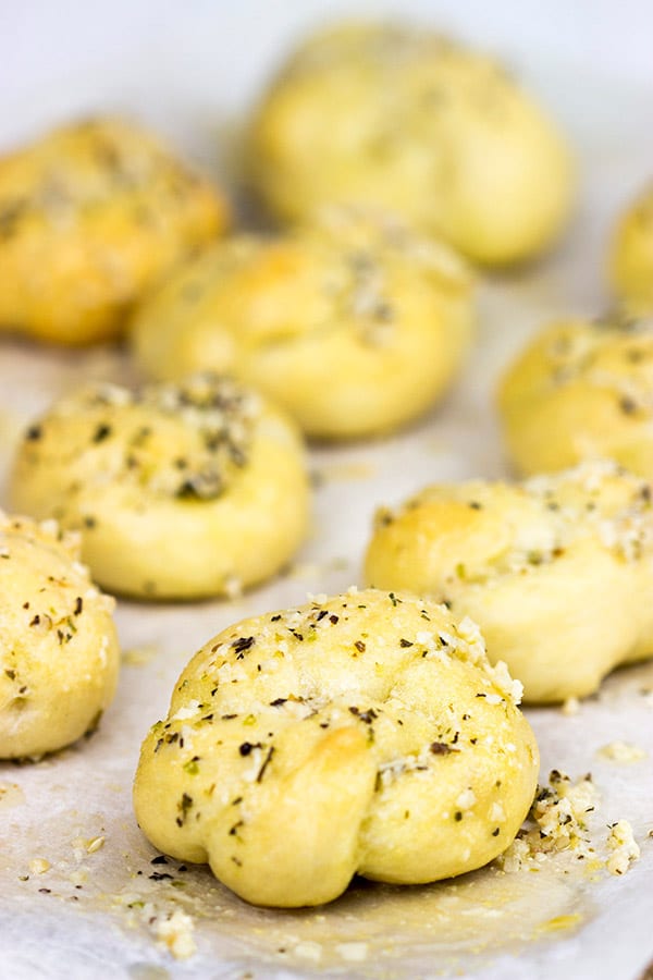 These Parmesan Garlic Knots are an easy, addicting appetizer! Soft homemade pizza dough is brushed with butter and sprinkled with garlic and Parmesan cheese! A perfect recipe for Game Day or any party!