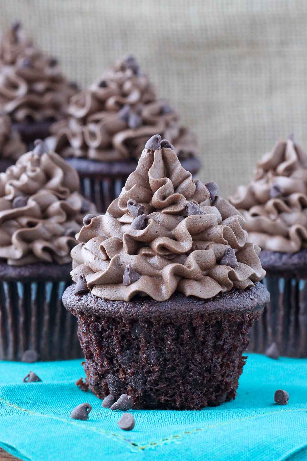 chocolate cupcake with chocolate frosting teal napkin.