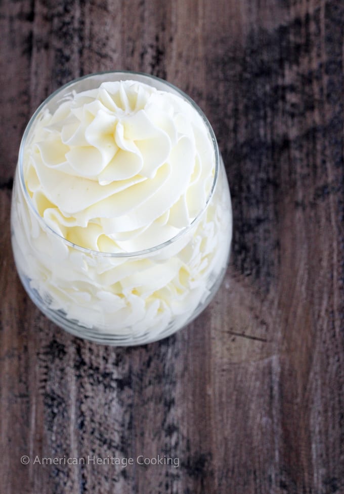 Italian meringue buttercream in a clear glass with graceful swirls.