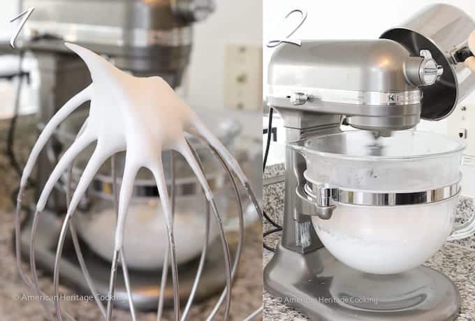 Egg whites whipped and shown on a silver whisk.