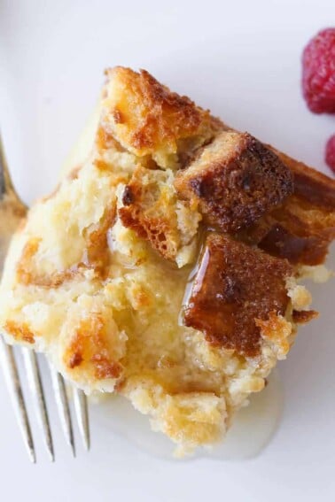 Lemon Raspberry Bread Pudding slice white plate fresh raspberries