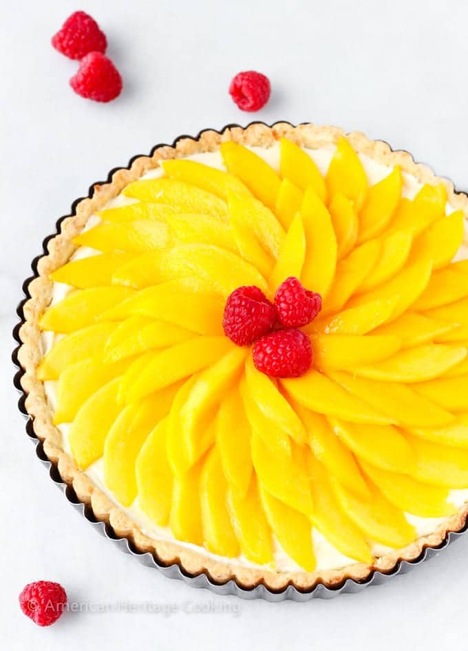 coconut mango tart on white background unsliced.