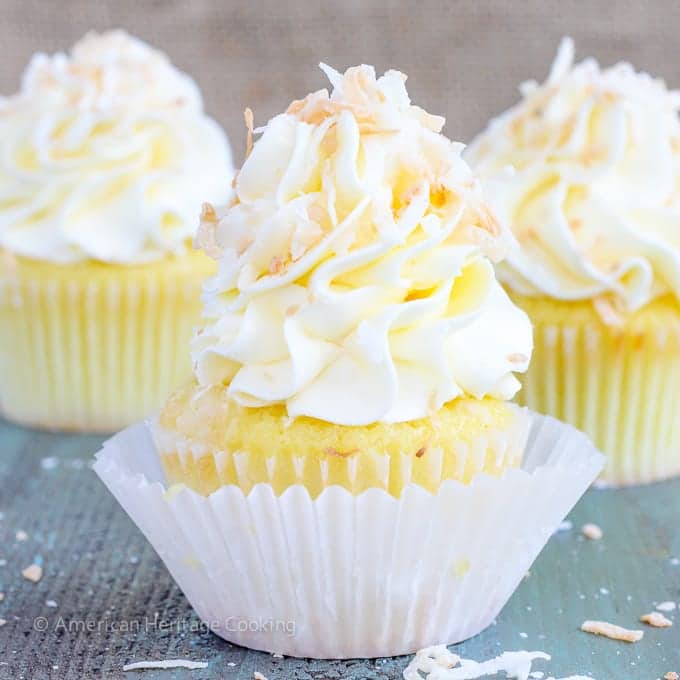 In these Lemon Coconut Cupcakes a moist coconut cupcake that is made with both dried coconut and coconut milk is filled with lemon curd and then topped with a coconut Italian Meringue Buttercream.  And then topped off with some more toasted coconut.