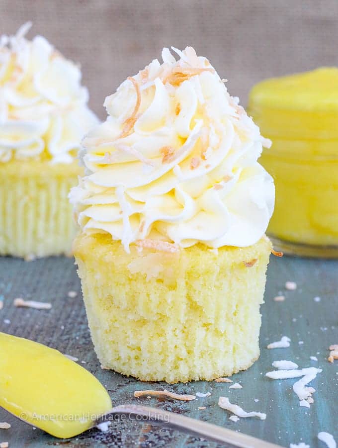 In these Lemon Coconut Cupcakes a moist coconut cupcake that is made with both dried coconut and coconut milk is filled with lemon curd and then topped with a coconut Italian Meringue Buttercream.  And then topped off with some more toasted coconut.