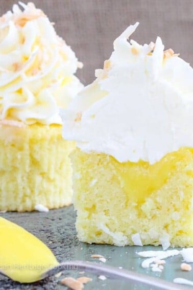 In these Lemon Coconut Cupcakes a moist coconut cupcake that is made with both dried coconut and coconut milk is filled with lemon curd and then topped with a coconut Italian Meringue Buttercream. And then topped off with some more toasted coconut.