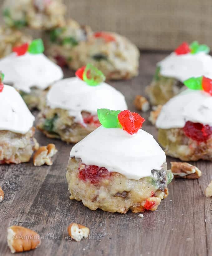 Fruitcake Cookies are chewy sugar cookies stuffed full of candied fruits, raisins and toasted pecans for a unique twist on the classic Christmas fruitcake! Topped with a brandy cream cheese frosting, these little cookies are irresistible! 