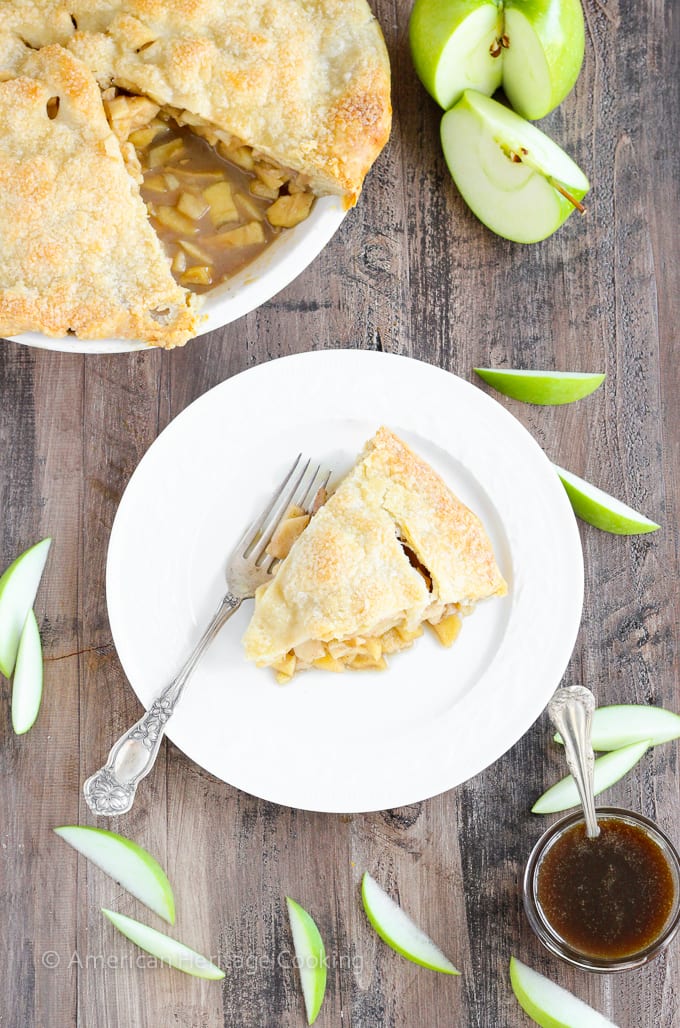 This Apple Butterscotch Pie is absolute heaven! Lightly spiced apples baked inside a flakey all-butter crust with brown sugar butterscotch sauce!