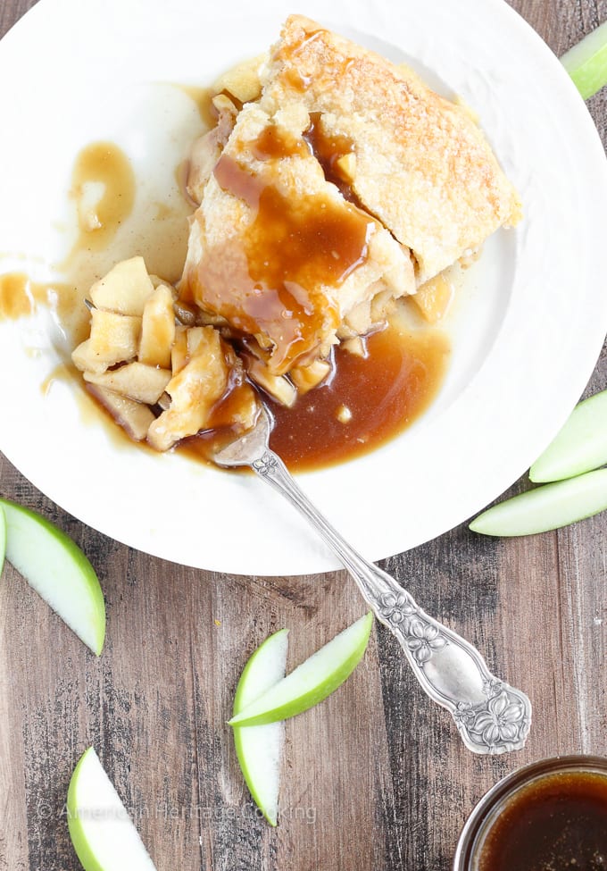 This Apple Butterscotch Pie is absolute heaven! Lightly spiced apples baked inside a flakey all-butter crust with brown sugar butterscotch sauce!