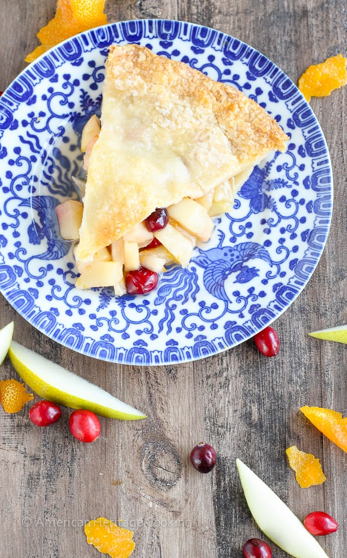 This Cranberry Orange Pear Pie has a sweet brown sugar orange pear filling and is studded with tart cranberries! With fresh orange juice, zest and Grand Marnier, the flavors are absolute heaven! 