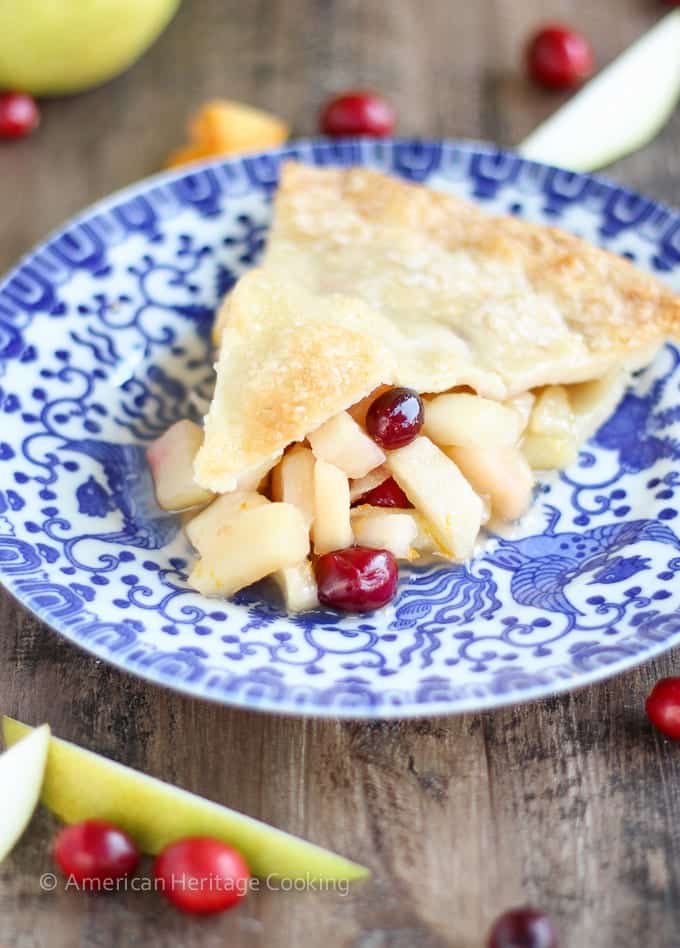 This Cranberry Orange Pear Pie has a sweet brown sugar orange pear filling and is studded with tart cranberries! With fresh orange juice, zest and Grand Marnier, the flavors are absolute heaven! 