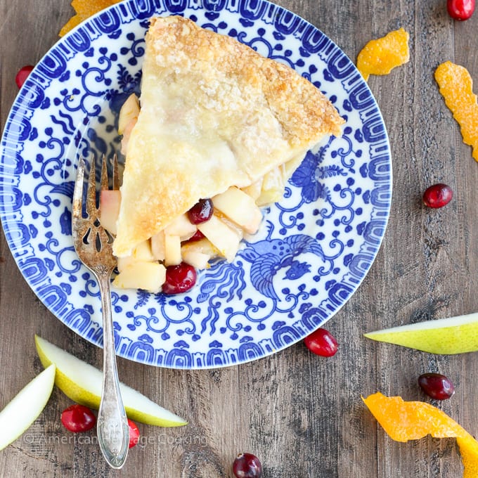 This Cranberry Orange Pear Pie has a sweet brown sugar orange pear filling and is studded with tart cranberries! With fresh orange juice, zest and Grand Marnier, the flavors are absolute heaven! 